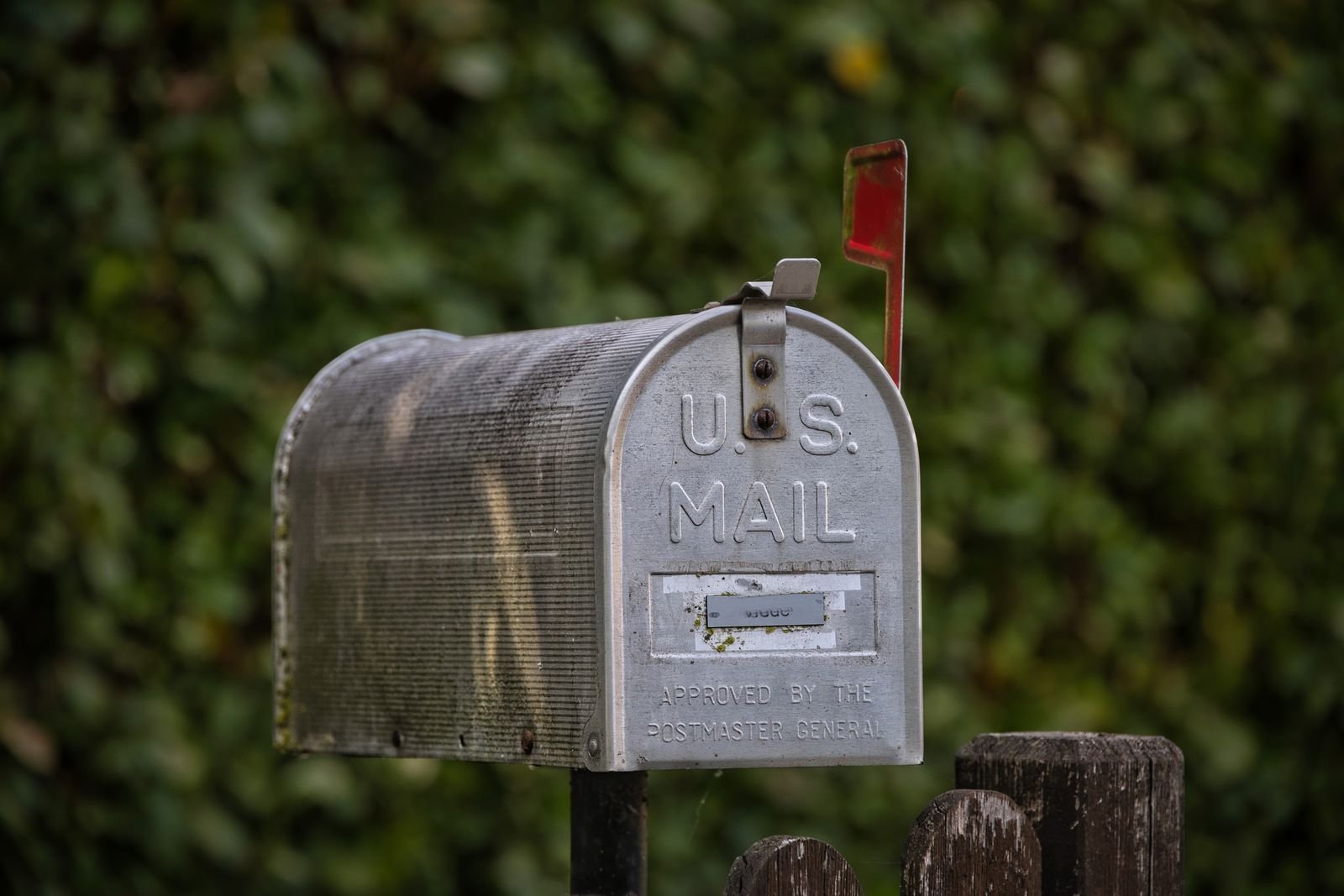 Direct mail postcards and letters in a mailbox representing B2B direct mail outreach