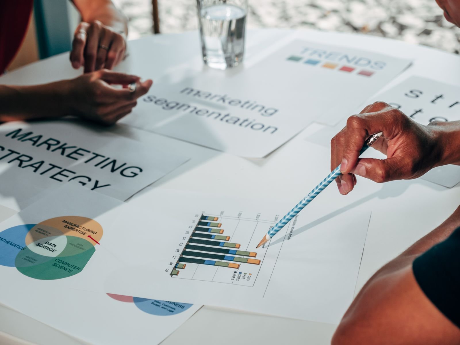 Marketing team reviewing email and direct mail campaign analytics side by side
